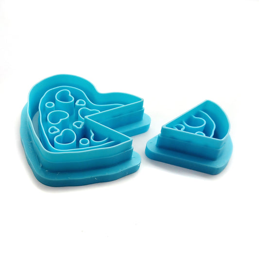 Blue clay cutters shaped like a heart and a slice of pizza