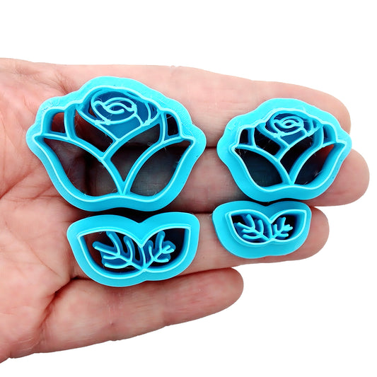 Set of blue rose-shaped clay cutters in a hand