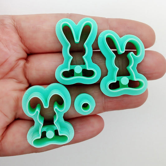 Set of bunny-shaped clay cutters on a hand