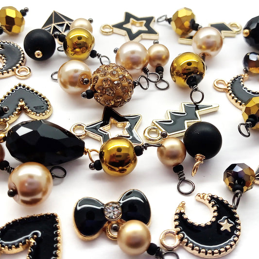 Black and gold charm assortment: metal enamel charms and handcrafted bead dangles.