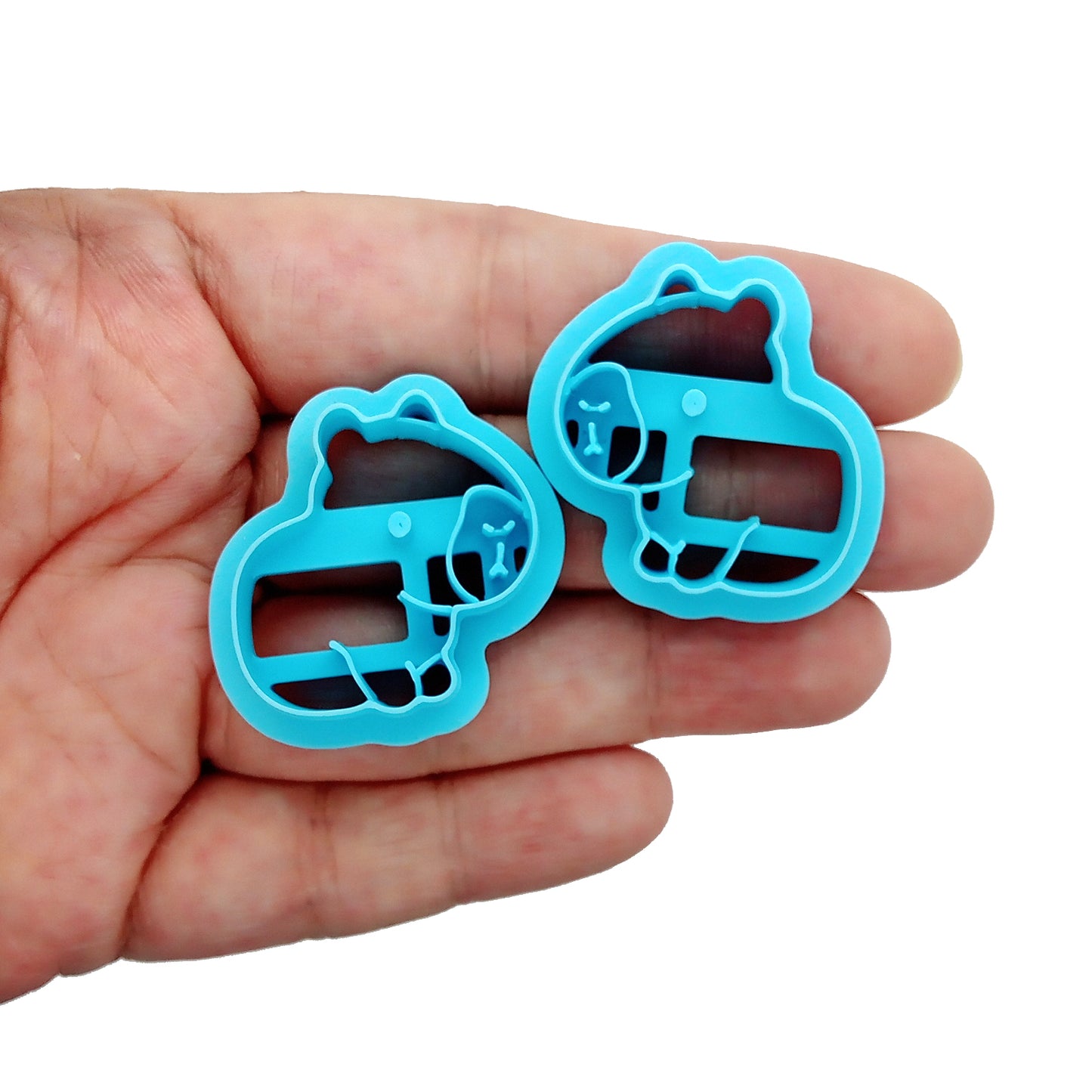Two cabybara clay cutters on a hand