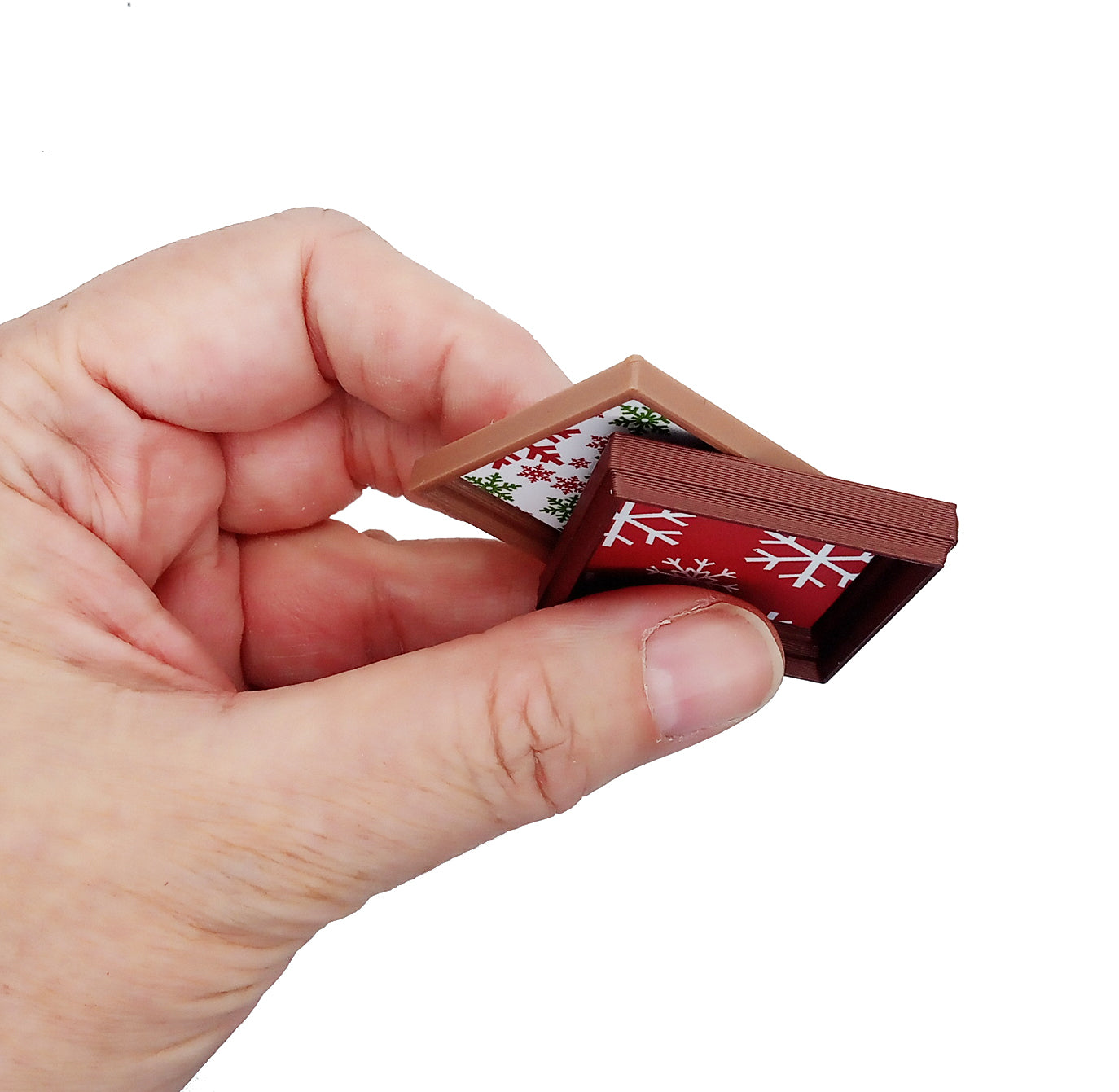 Side detail of framed Christmas prints for small dollhouses.