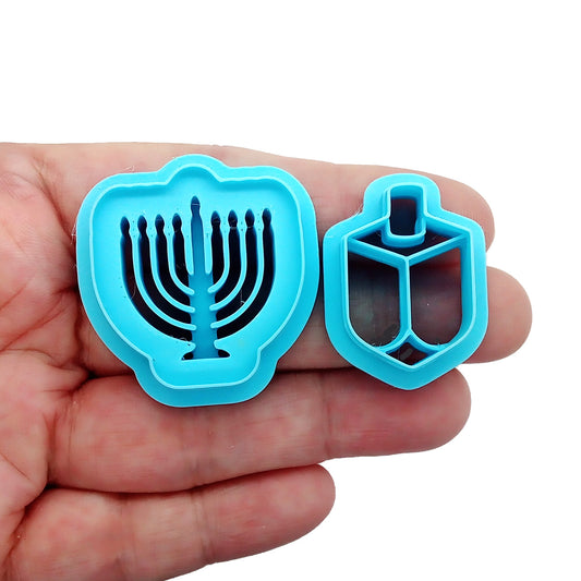 Polymer clay cutters in Hanukkah shapes: menorah and dreidl