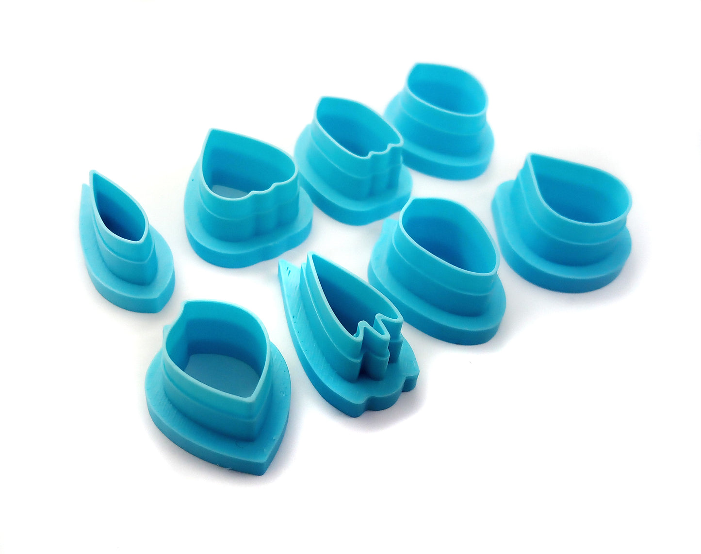 View of 8 different shapes of flower petal clay cutters.