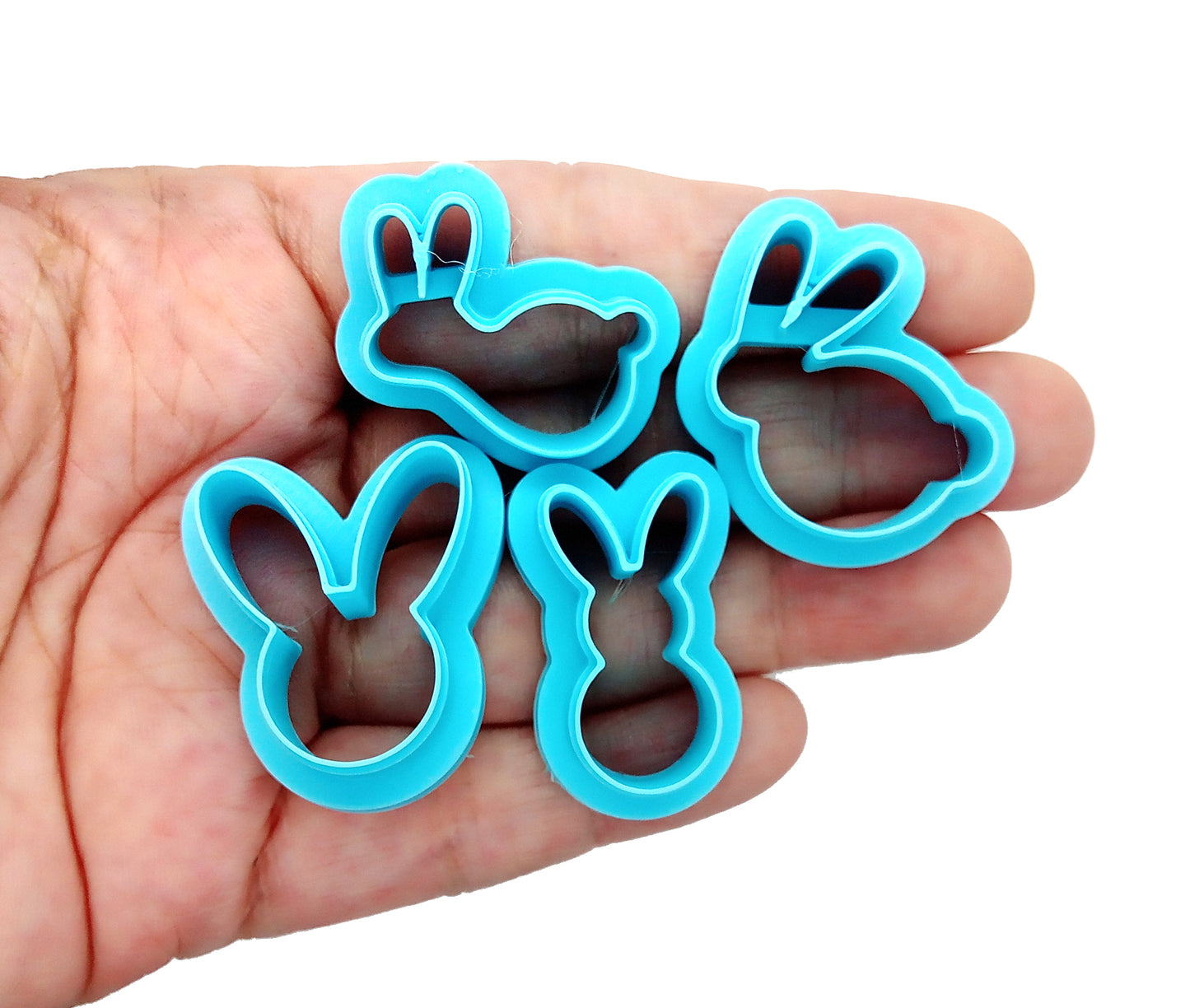 Easter Bunny Clay Cutters: Set of 4 Shapes showing sturdy sharp blades for polymer clay crafting in a hand.