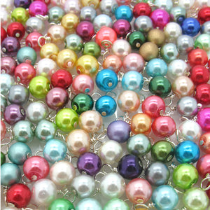 Many colors of glass pearl charms.