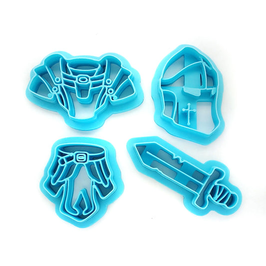 Set of blue clay cutters shaped like a helmet, sword, and armor on a white background.