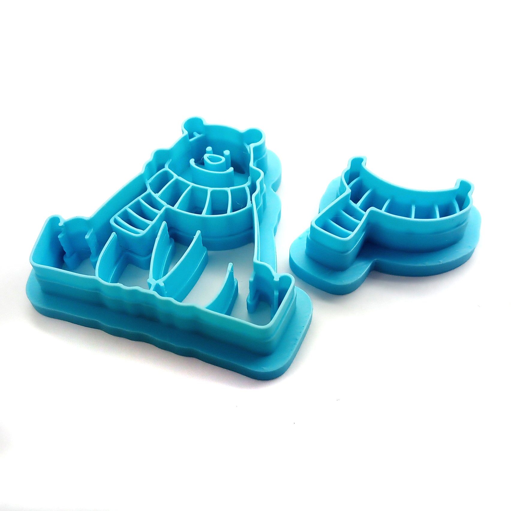 Blue bear-shaped clay cutter against a white background