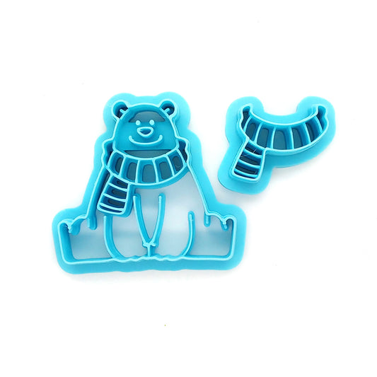 Blue bear-shaped clay cutter against a white background