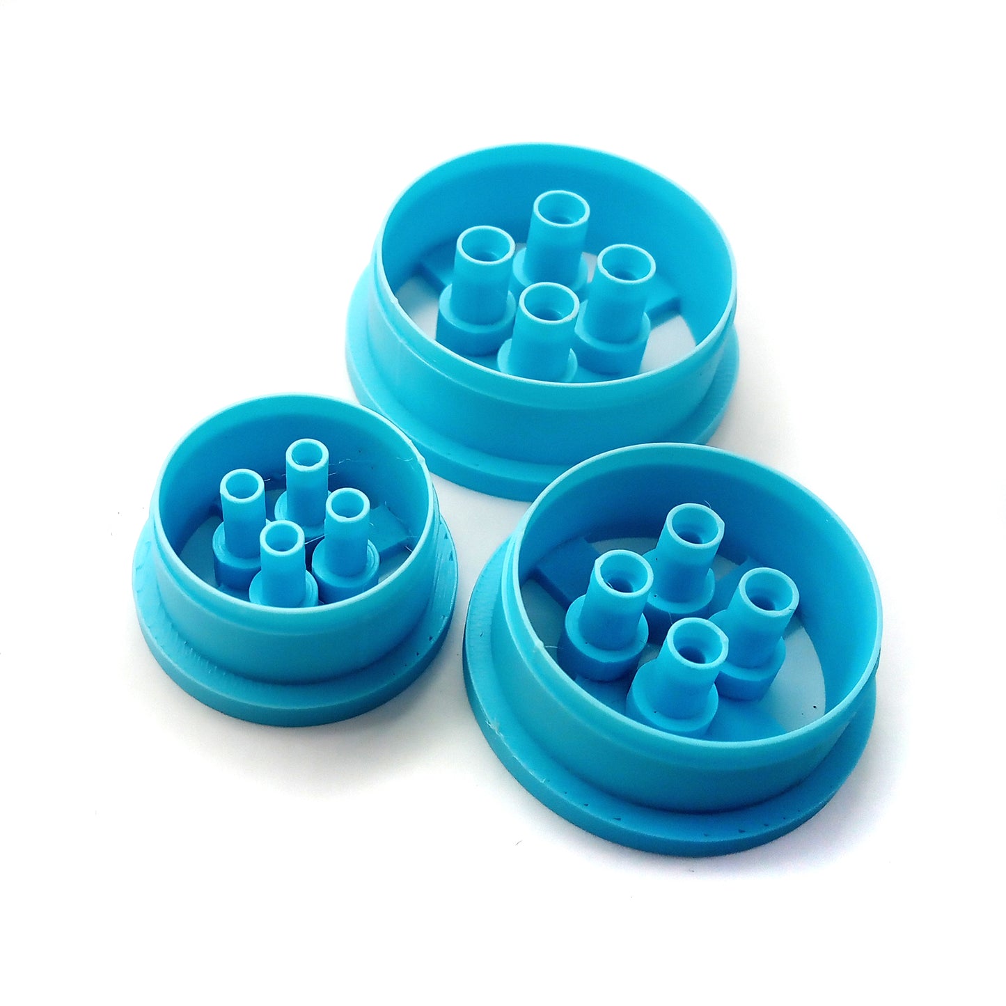 Three button clay cutters in different sizes.