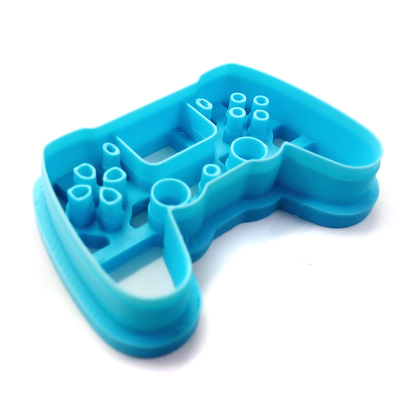 Blue clay cutter shaped like a video game controller on a white background