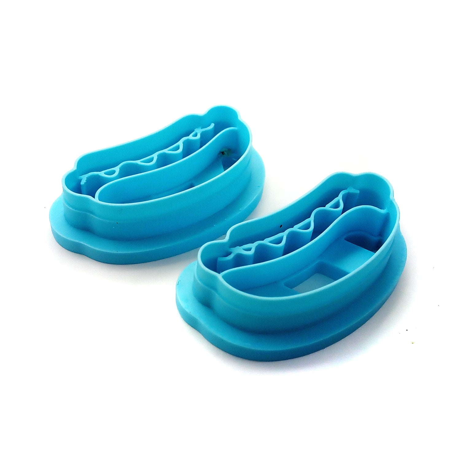 Two hot dog clay cutters on a white background.