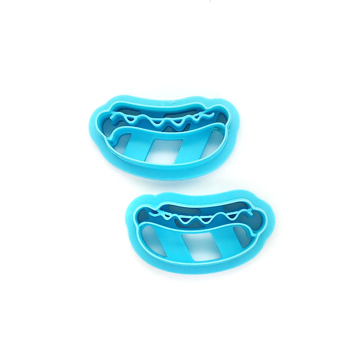 Two hot dog clay cutters on a white background.