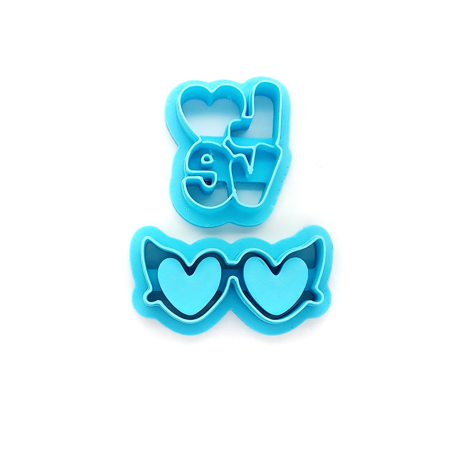 Blue clay cutters with the word "love" and heart-shaped sunglass lenses.