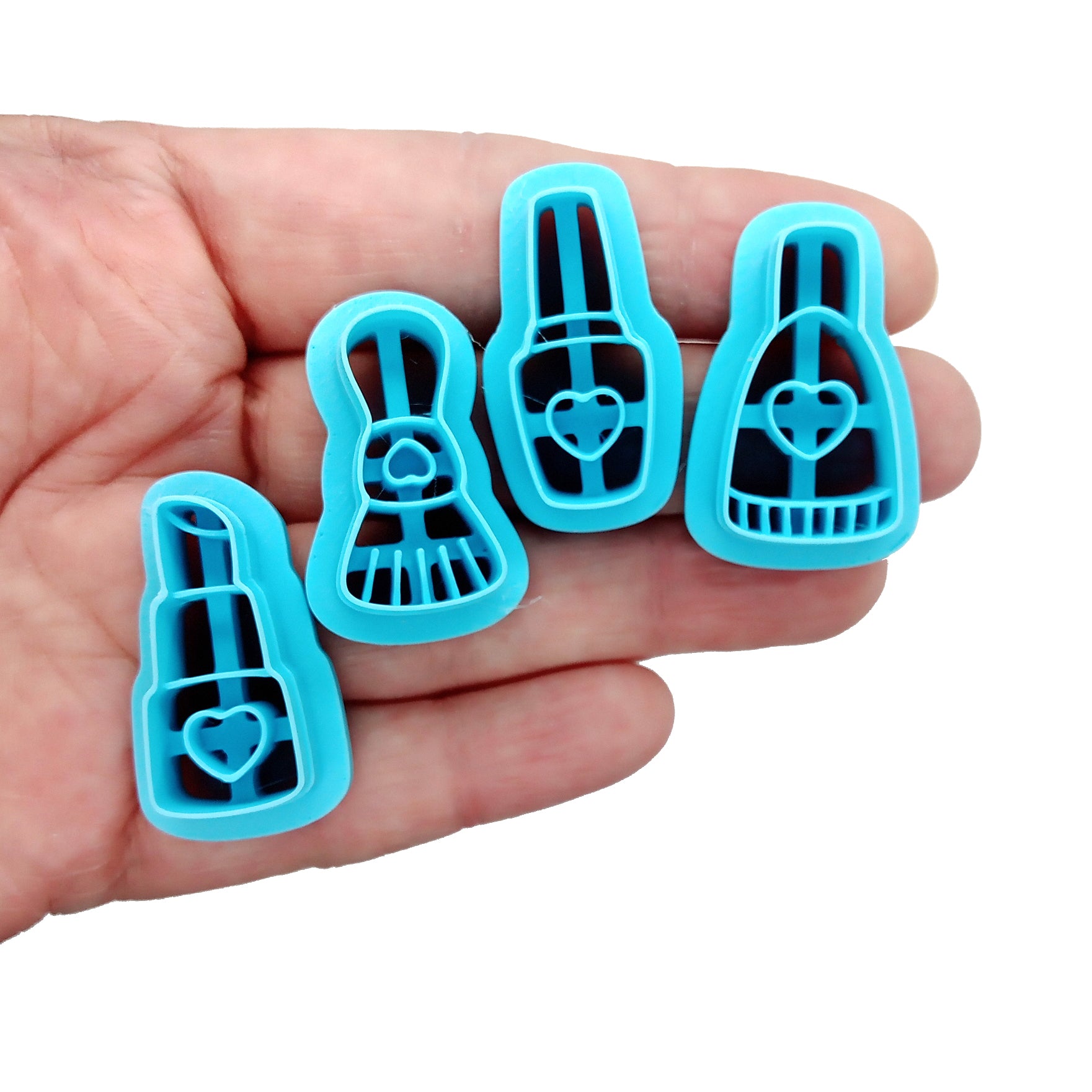 Clay cutter set: 4 makeup and beauty care shapes held in a hand.