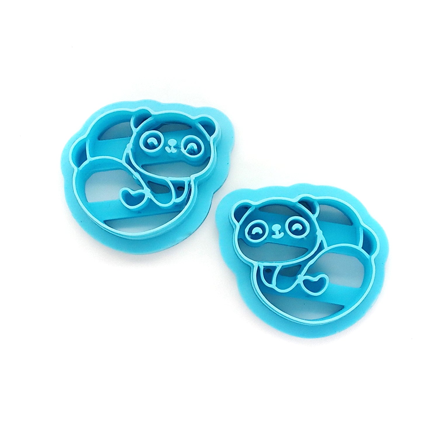 Two blue panda-shaped clay cutters on a white background