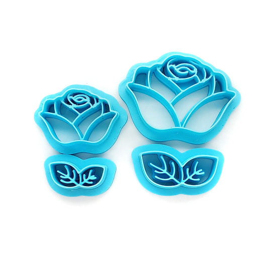 Set of blue rose-shaped clay cutters on a white background