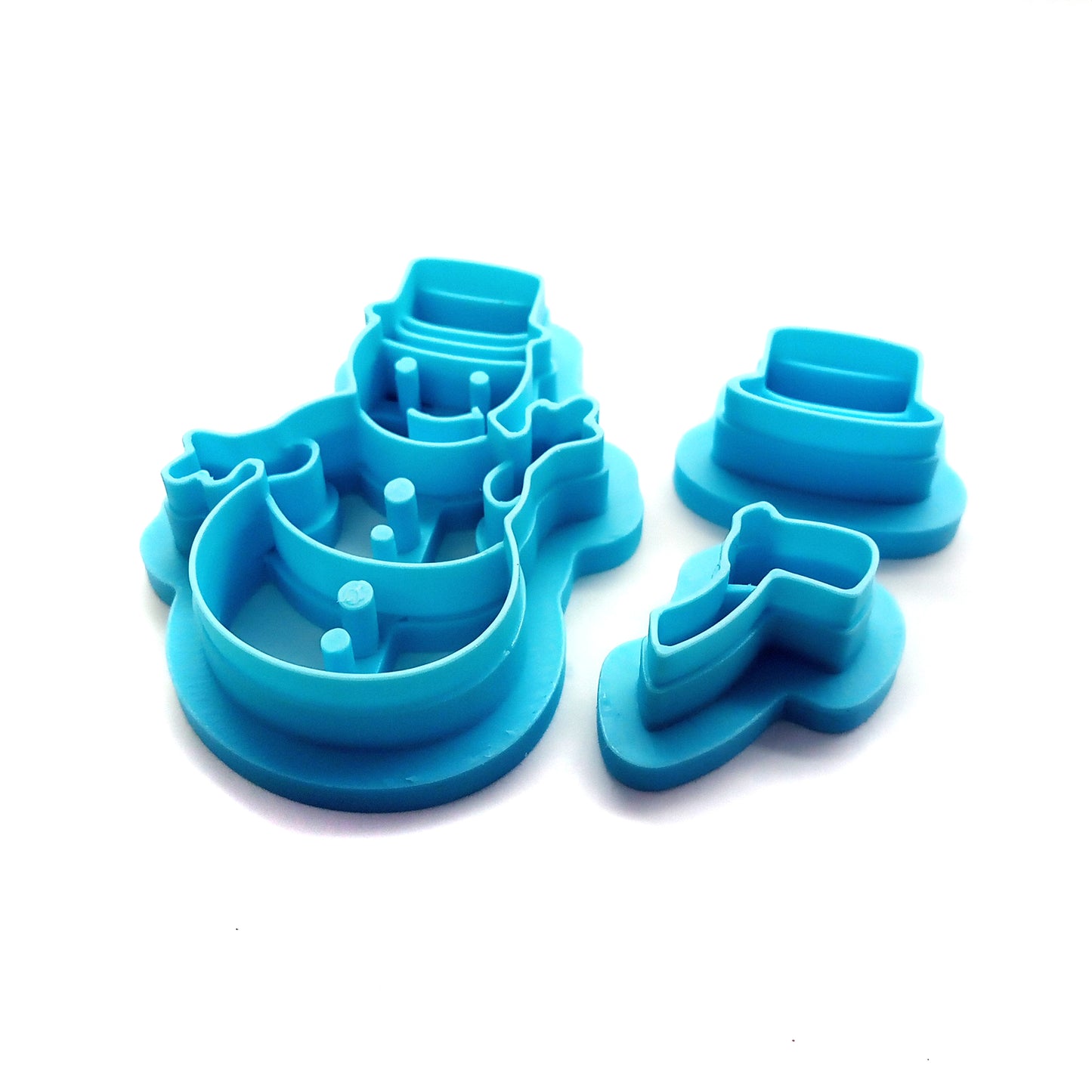 Set of blue snowman-themed clay cutters on a white background
