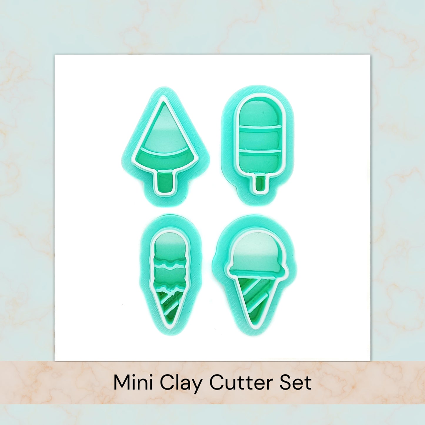 Set of four mini clay cutters shaped like ice cream cones, ice pops, and a slice of watermelon on a light blue background.