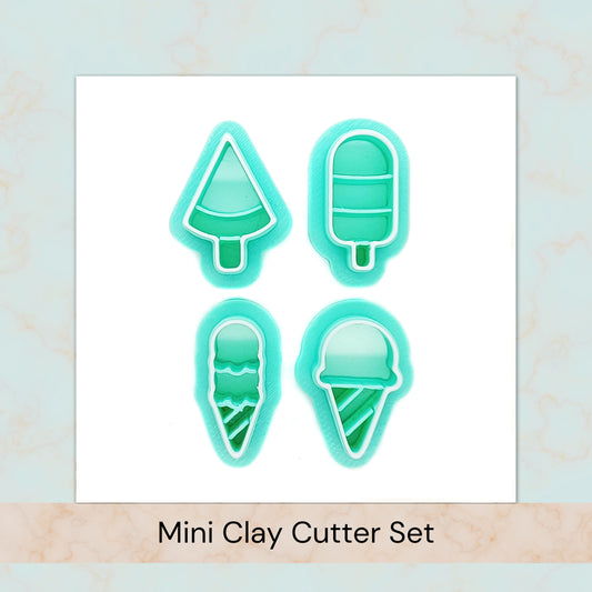Set of four mini clay cutters shaped like ice cream cones, ice pops, and a slice of watermelon on a light blue background.