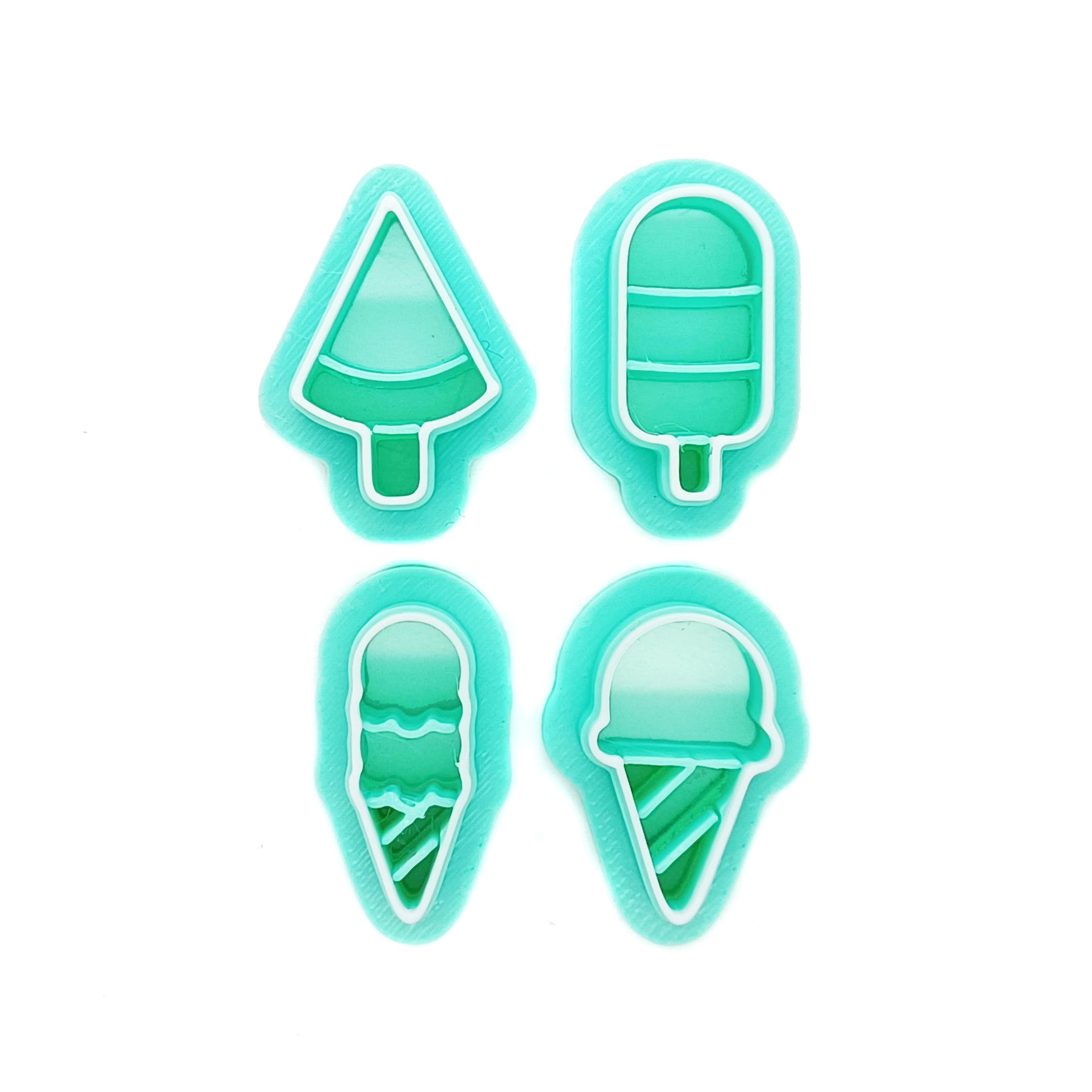 Set of small green clay cutters in ice cream and ice pop shapes