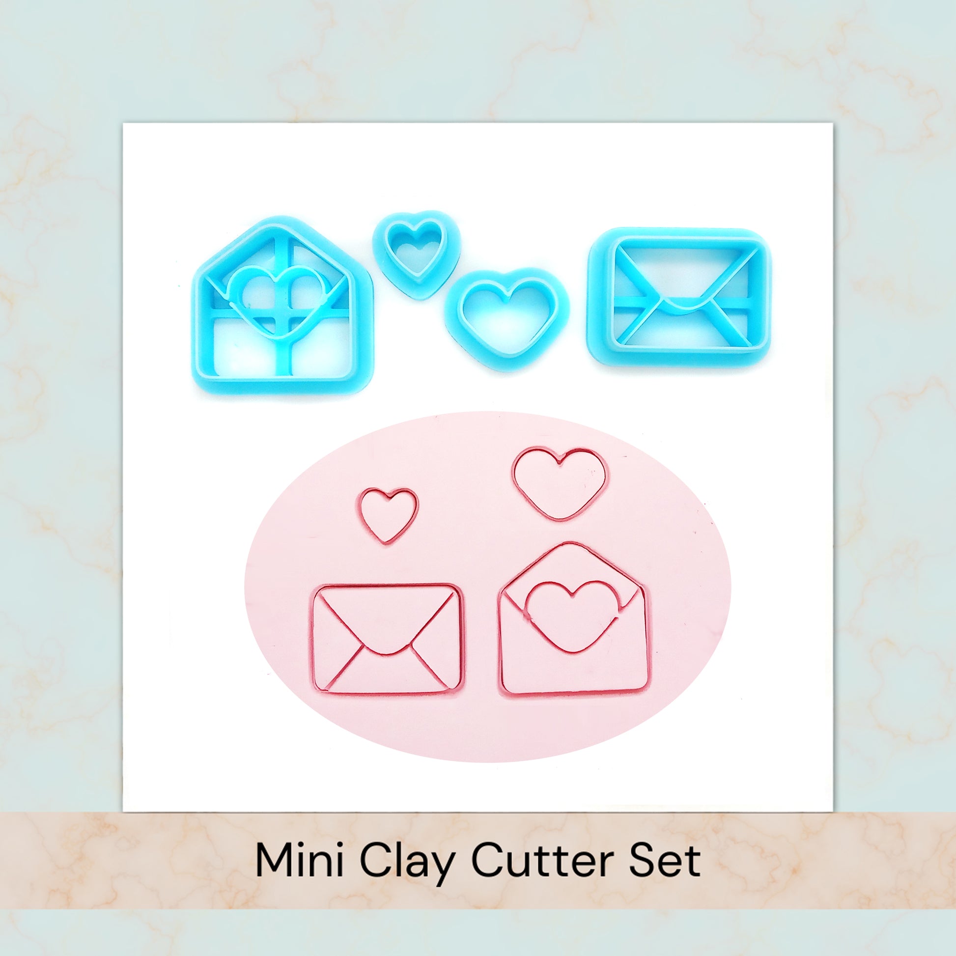 Set of blue clay cutters shaped like hearts and envelopes on a white background
