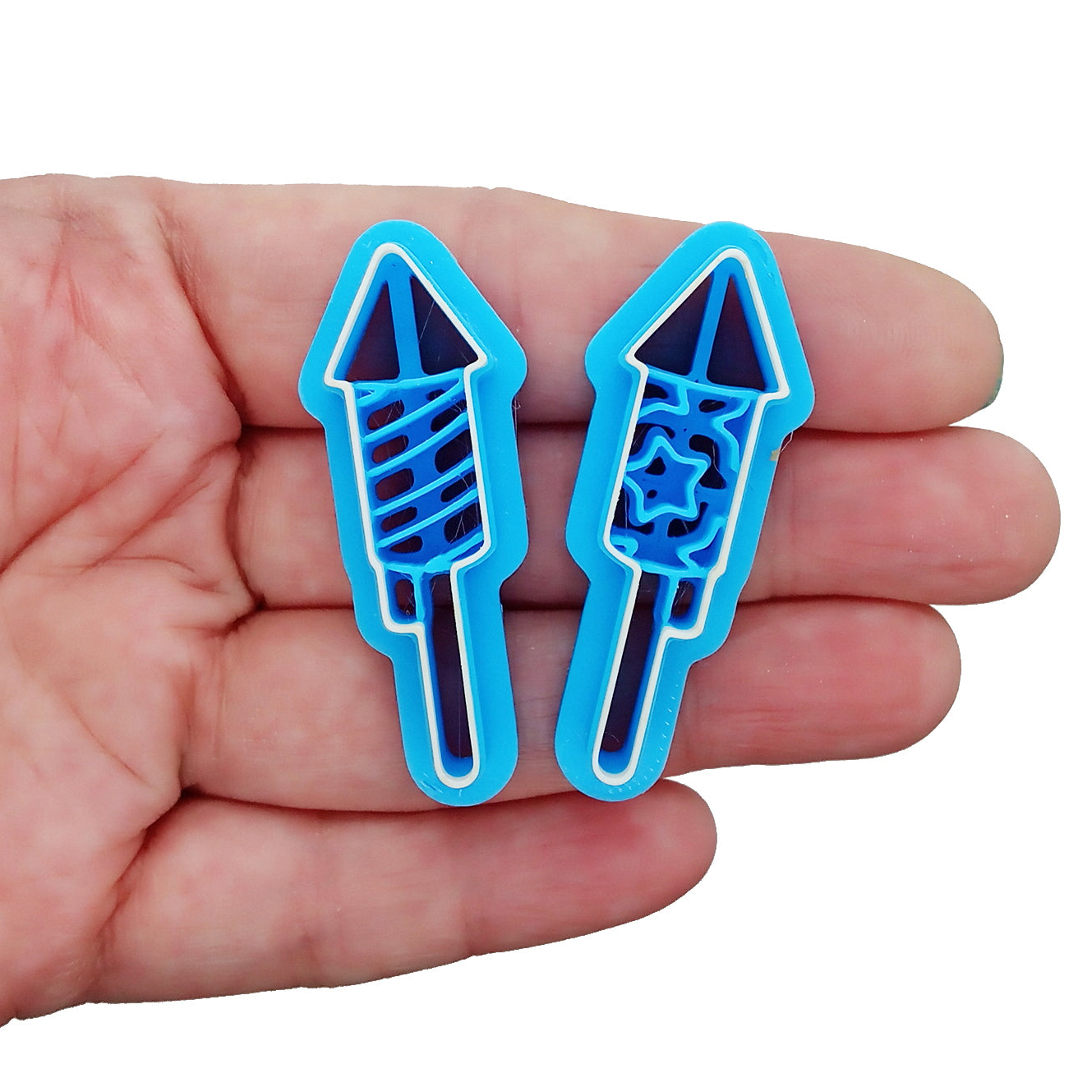 Clay cutter set with two blue fireworks cutters in a hand