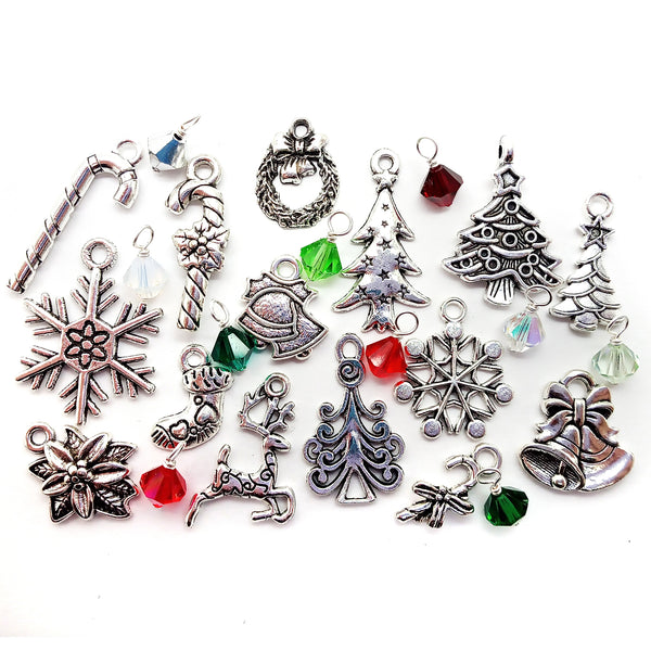 Mix of metal Christmas charms in silver-tone alloy: trees, candy canes, stockings, snowflakes pointsettia, reindeer and wreath. Red, green and white bicone bead dangles are included.