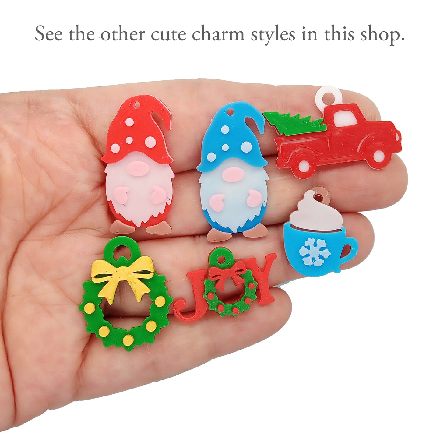 A variety of Christmas charms: 3D printed trucks, cocoa, joy, gnomes, wreaths.
