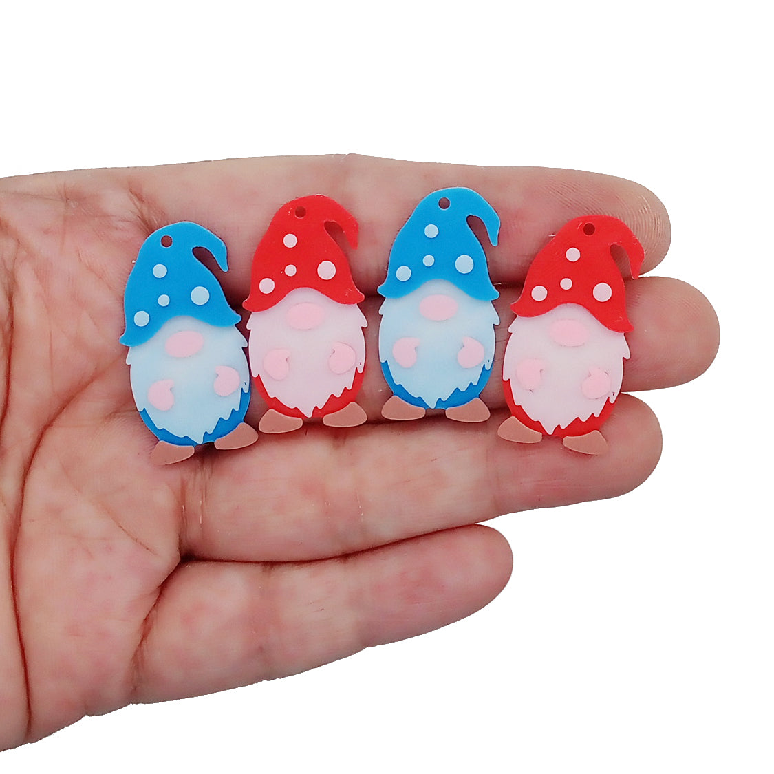 Cute gnome charms, 3D printed in red and blue PLA, with brown shoes and white polka dots.
