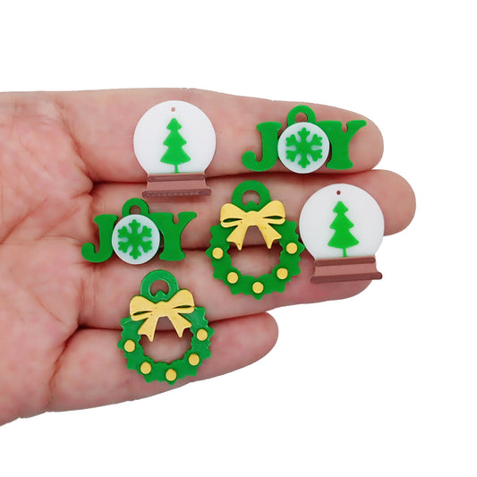 Green Christmas Charms, 3D printed: snow globes with trees, joy shapes with snowflakes, and green wreaths with gold ribbon.