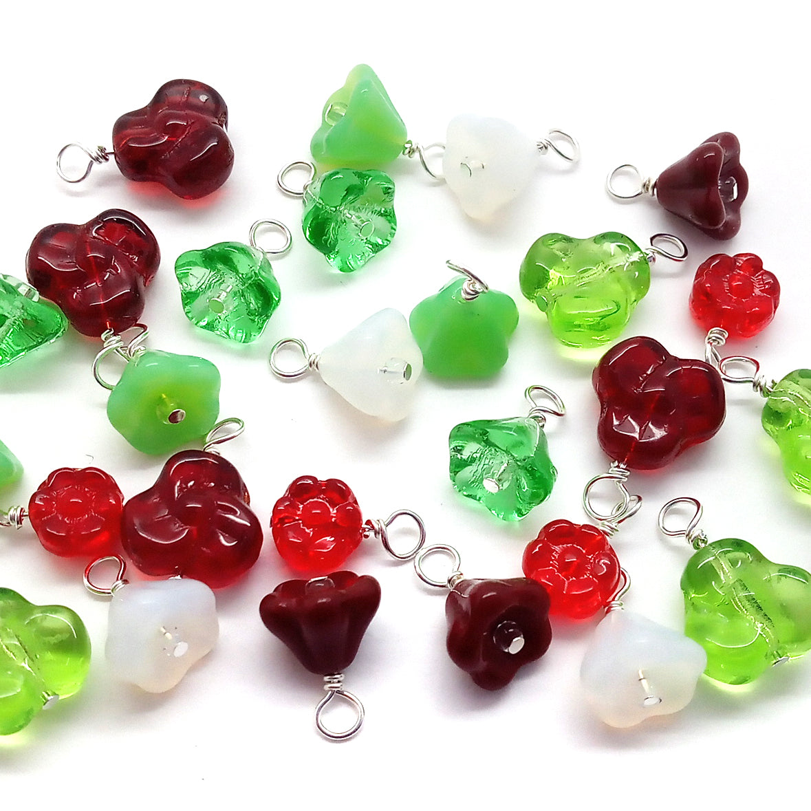 Floral bead dangles in Christmas colors, red and green glass bead flower charms.