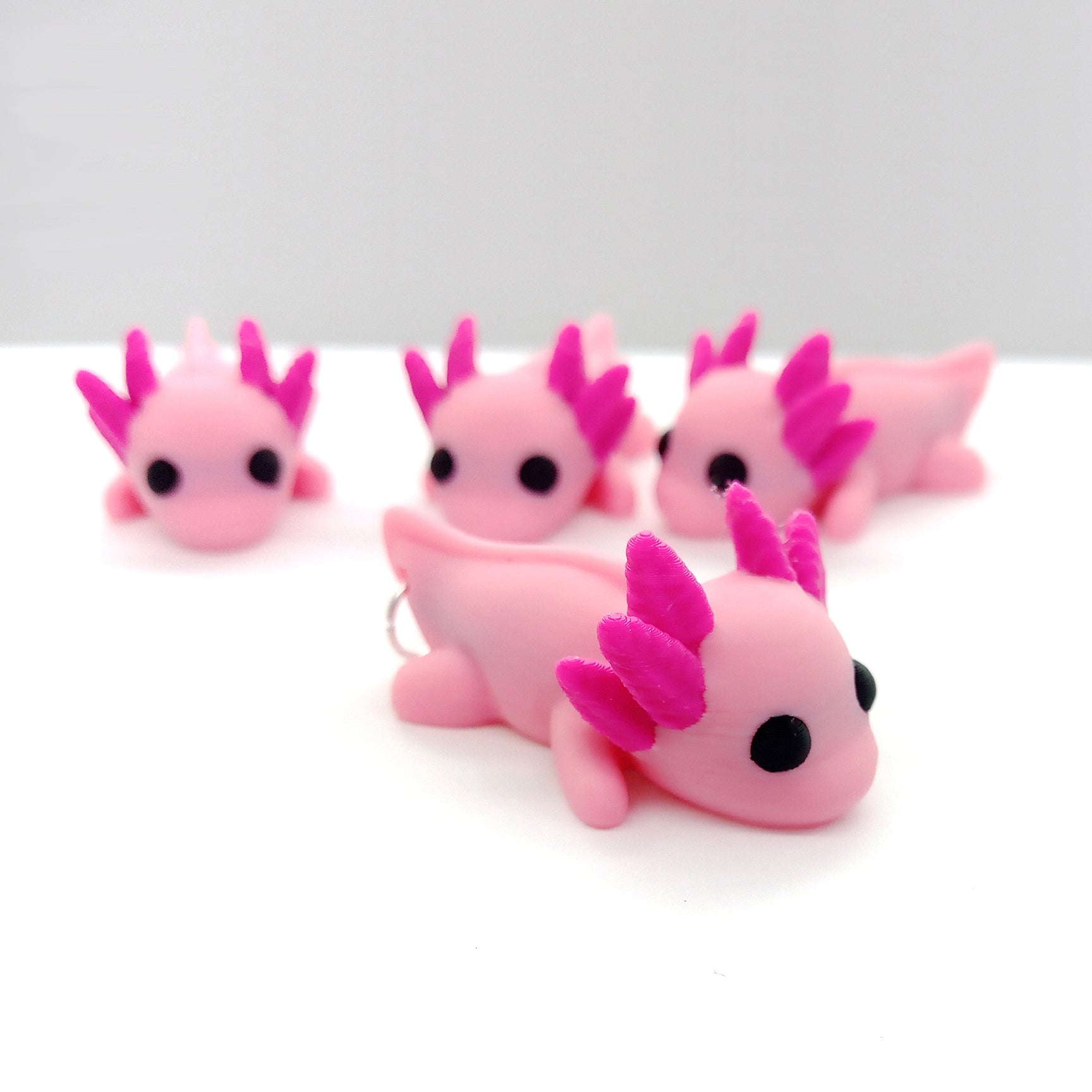 Cute pink baby axolotl charms or pendants for jewelry making.