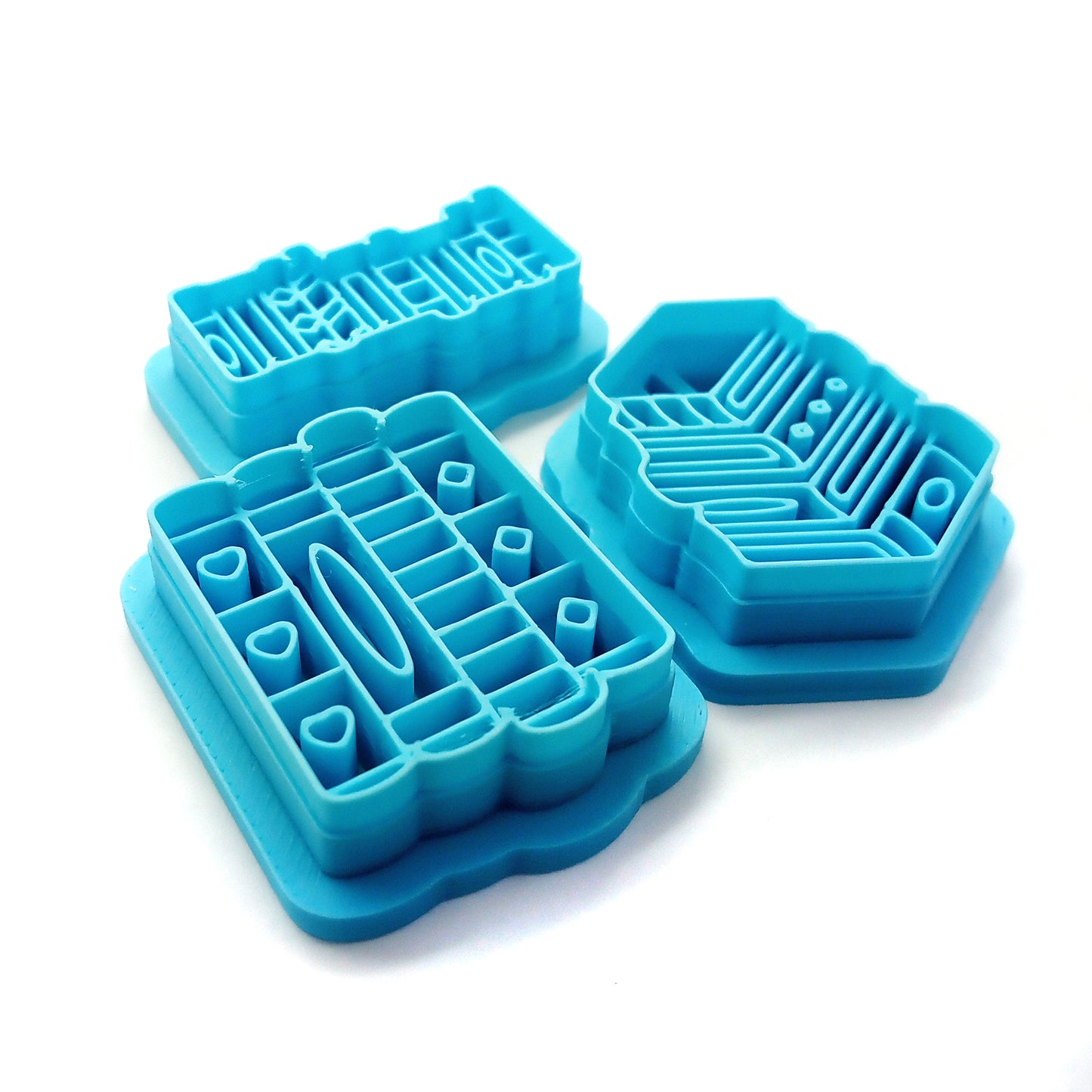 Set of blue clay cutters shaped like books on a white background