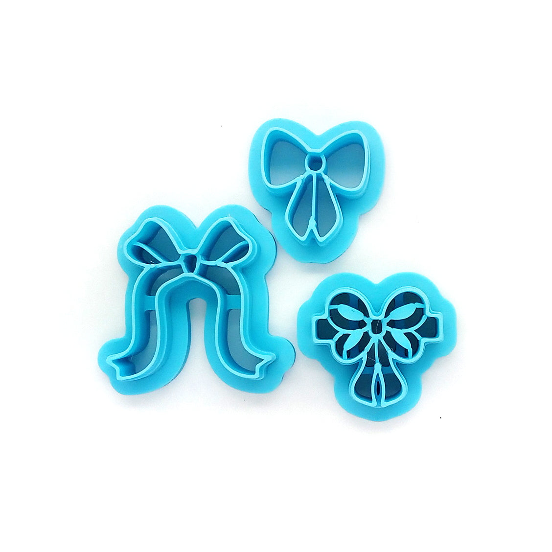 Three blue bow-shaped clay cutters 