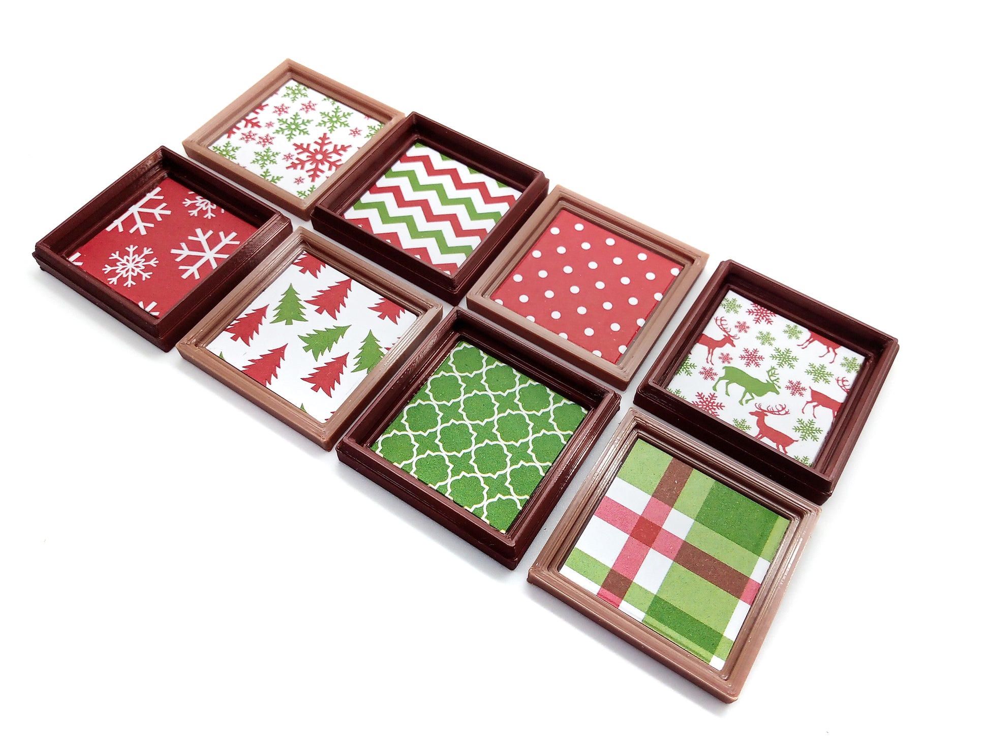 Eight framed Christmas prints for small dollhouses, including snowflakes, plaid, reindeer, polka dots and Christmas trees.