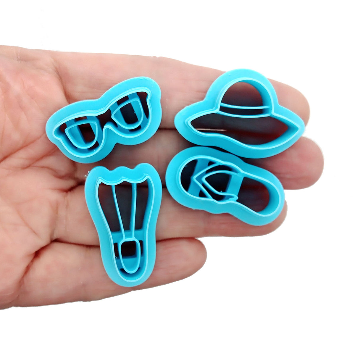 Summer vacation or beach clay cutter set: flipper, flip flop, sun hat and sunglasses.