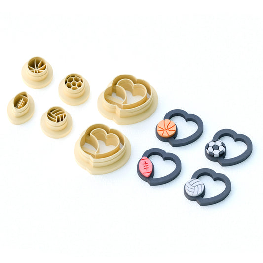 Set of clay cutters with large hearts holding sports balls