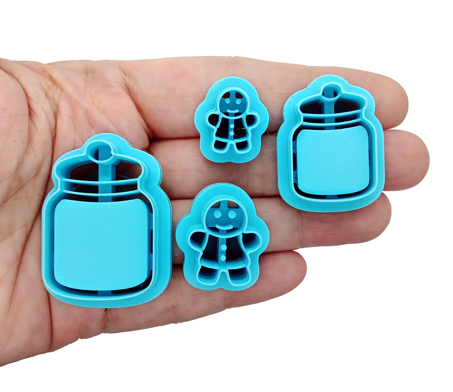 Gingerbread Man Clay Cutters with Cookie Jars, Set of 4 featuring lightweight plastic cutters with sturdy sharp blades.