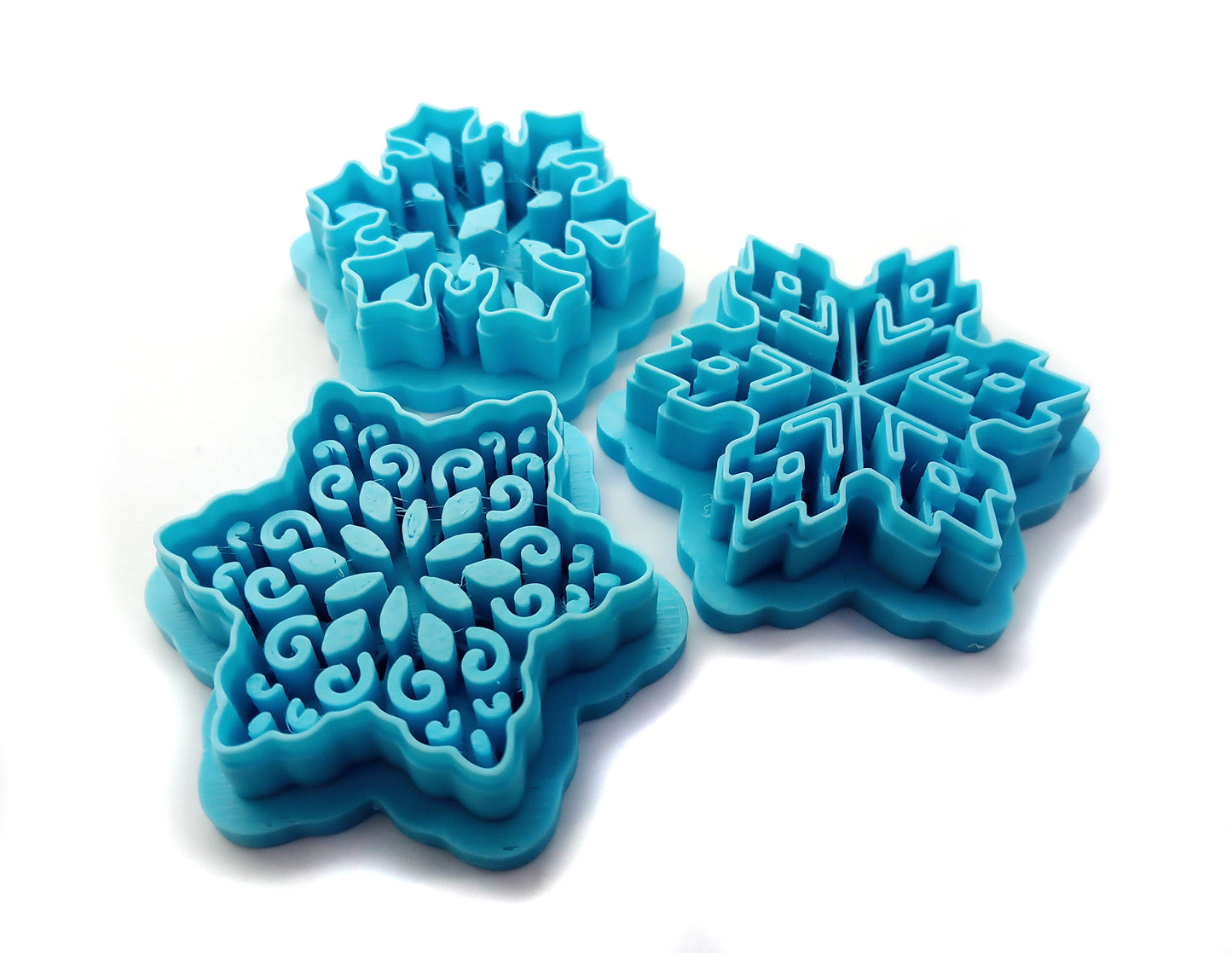 Intricate Snowflake Clay Cutters: Set of 4 in blue color, featuring sturdy sharp blades for polymer clay crafting.
