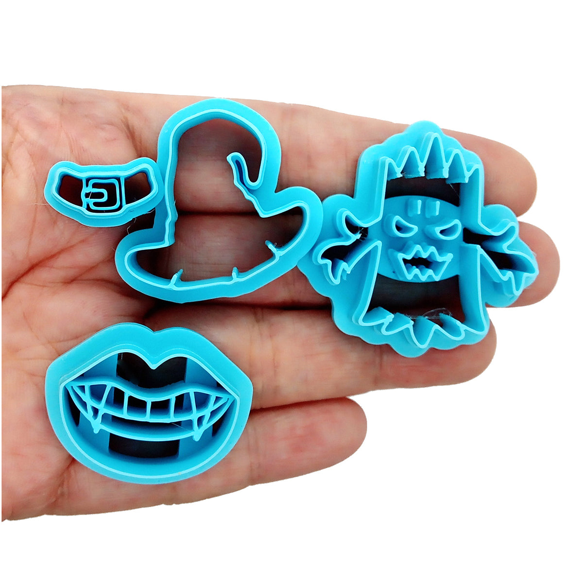 Polymer clay cutter set for Halloween: vampire fangs, witch hat and spooky tree.