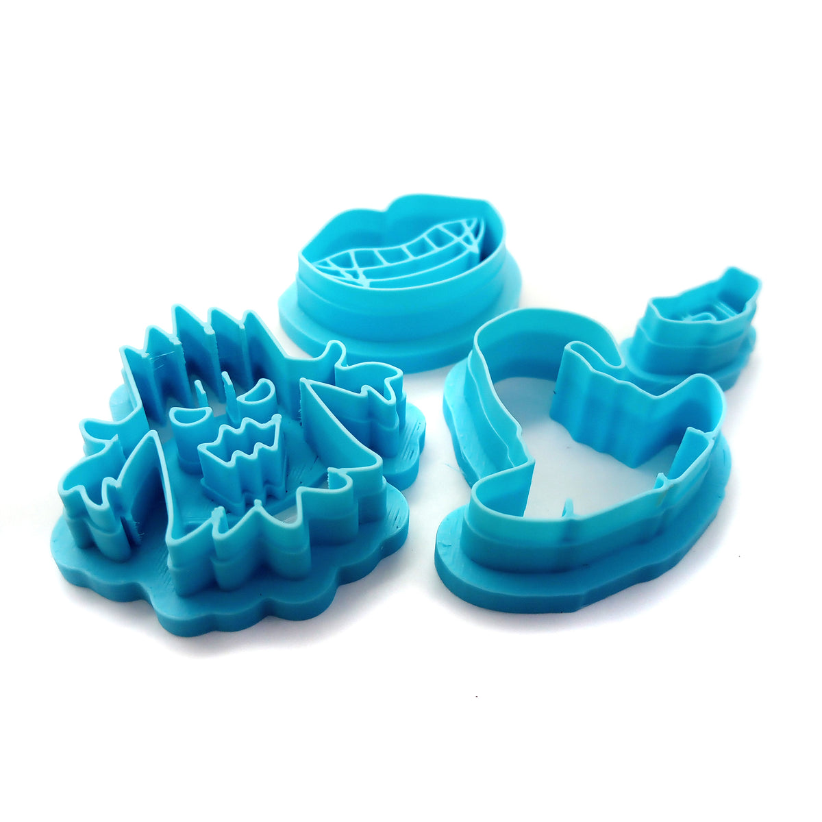 Polymer clay cutter set for Halloween: vampire fangs, witch hat and spooky tree.