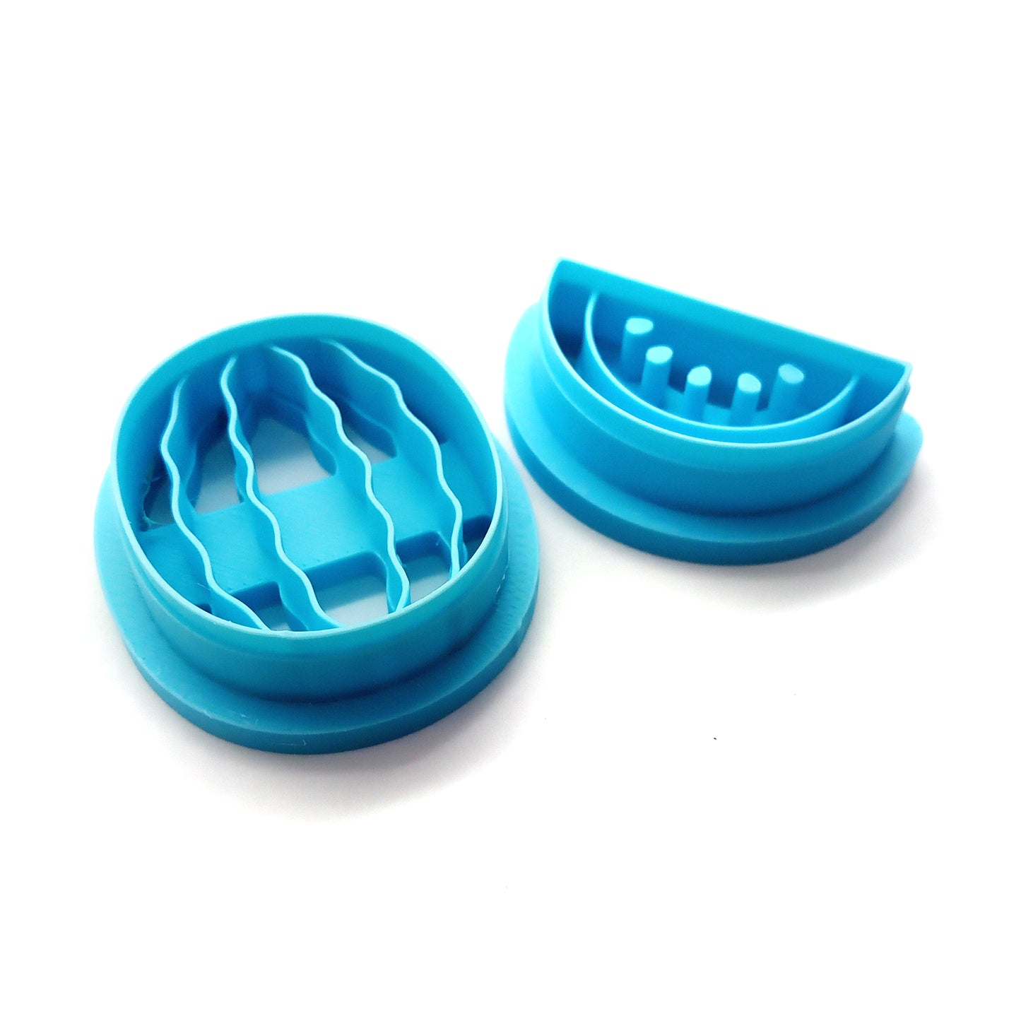 Set of blue clay cutters shaped like watermelons on a white background