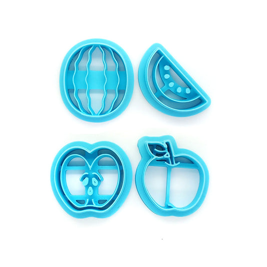 Set of blue clay cutters shaped like watermelons and apples on a white background