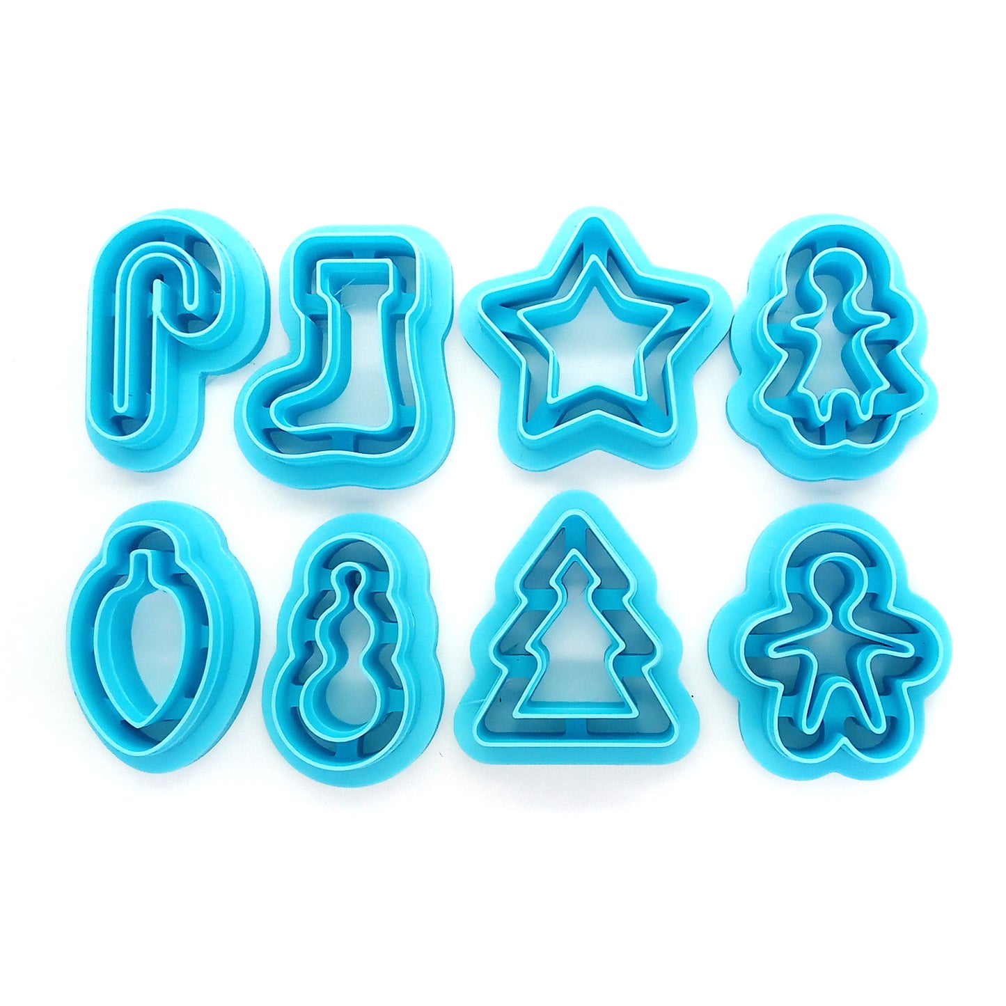 Set of blue Christmas or winter-themed clay cutters: candy cane, stocking, star, gingerbread woman, bulb, snowman, tree and gingerbread man.