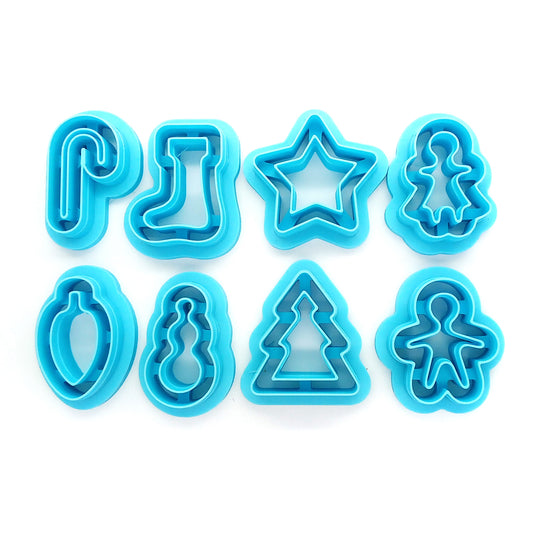 Set of blue Christmas or winter-themed clay cutters: candy cane, stocking, star, gingerbread woman, bulb, snowman, tree and gingerbread man.