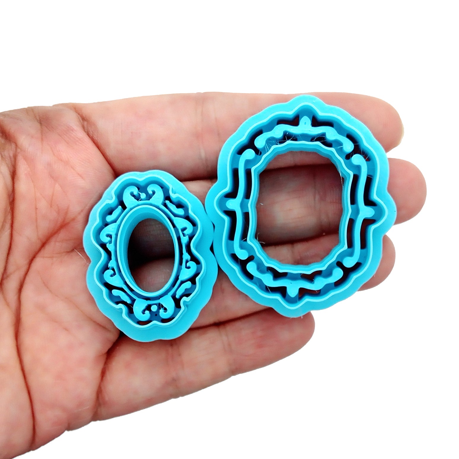 Fancy Frame clay cutters held in a hand