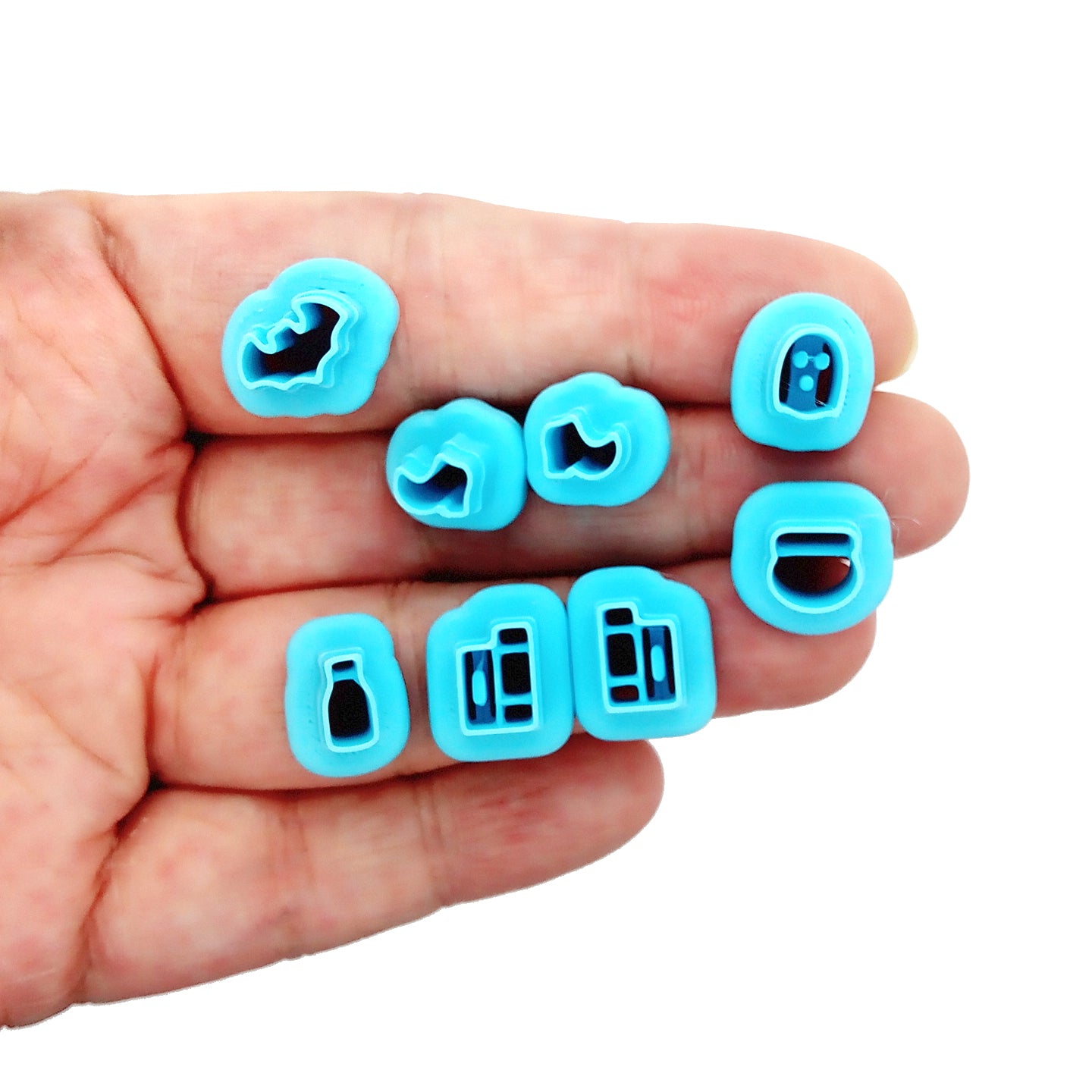 Set of tiny clay cutters in Halloween shapes: ghost, bat, potions,witch boots and spell books.