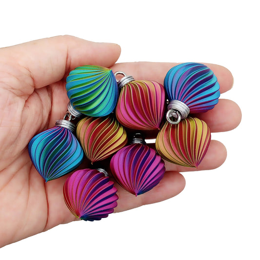 Small swirl ornaments in rainbow ombre colors, measuring 1 inch tall.