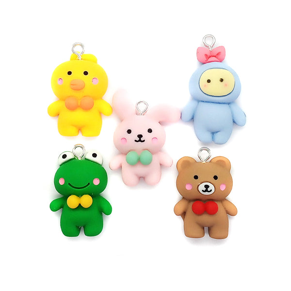 Adorable animal charms made from resin flatback cabochons: yellow chick, pink rabbit, green frog, brown bear with bow, and cute blue friend.